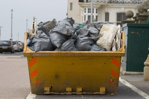 Construction site with a large skip in Surbiton